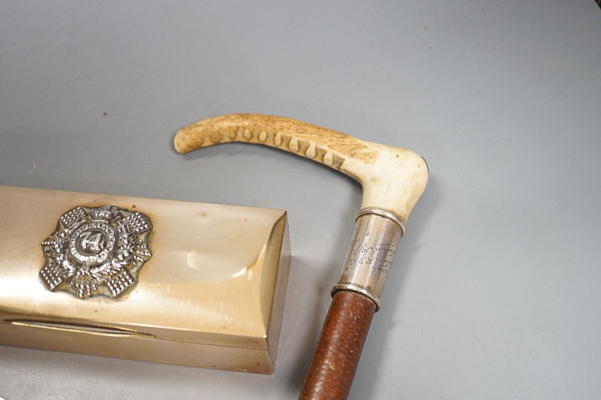 World War memorabilia, riding crop, ash tray, POW match case, 74th Highlanders brass case and a memorial plaque, Highlanders case 17cms wide.